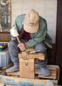 Craftsman making spoons